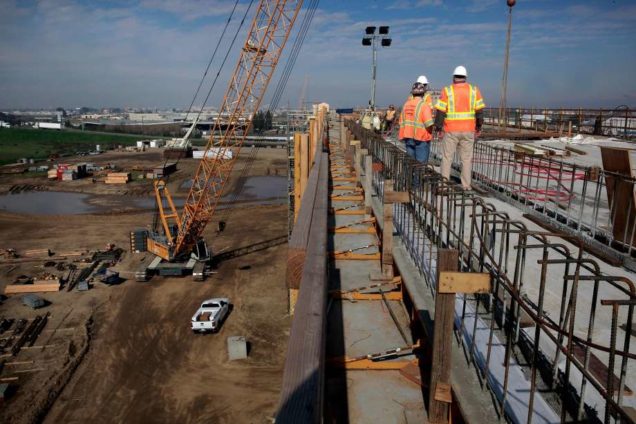 A construction crew works on an elevated section of track for the high-speed rail system in Fresno in February. Photo: Michael Macor, The Chronicle